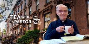 Image of Monsignor Massie sipping tea in brownstone brooklyn